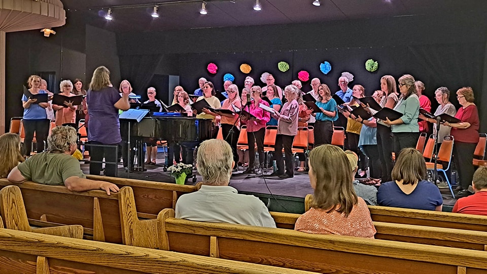 Volunteer with tuck cart visiting patient